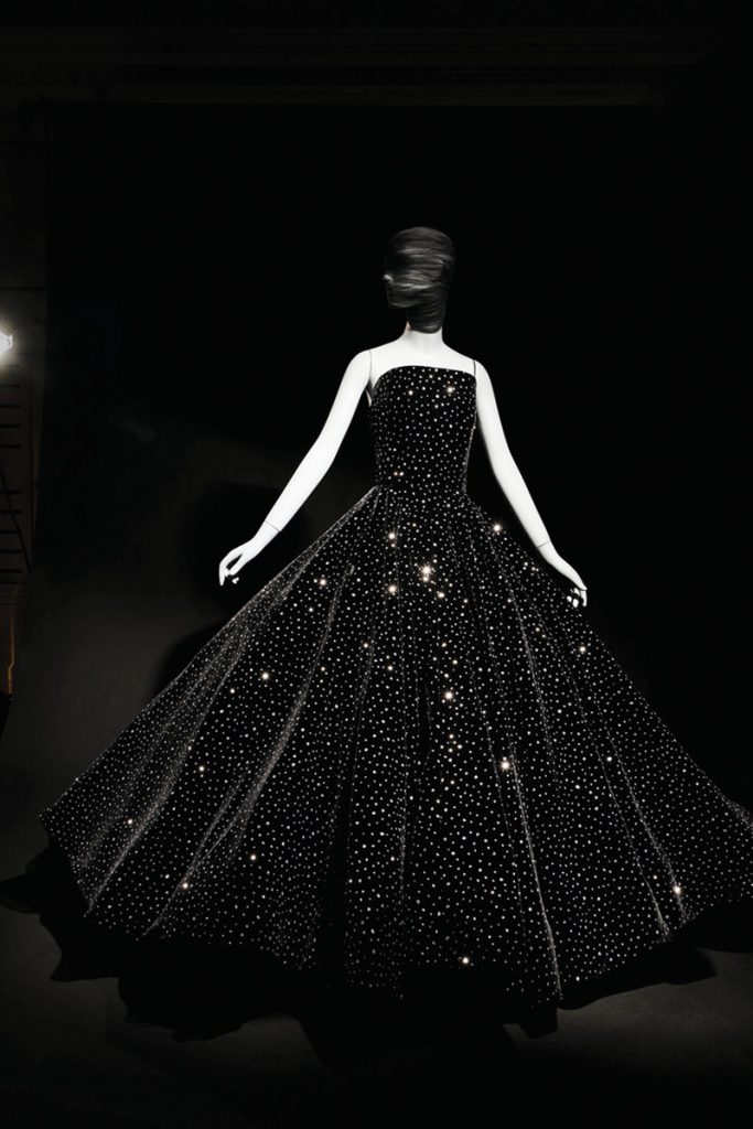 The crystal velvet ball gown from the Fall 2018 collection sparkles in the light from the clusters of glitter applied to the fabric