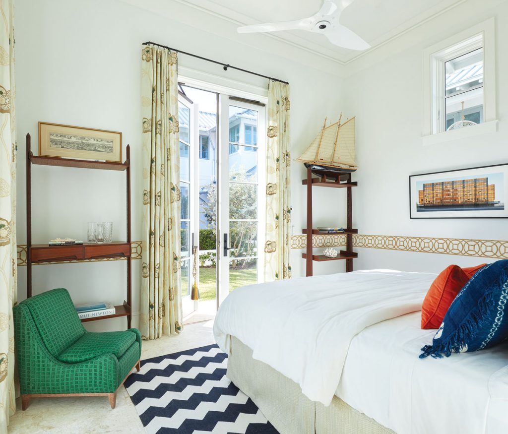 A sunny guest bedroom opens to the backyard. Photography by Brantley Photo