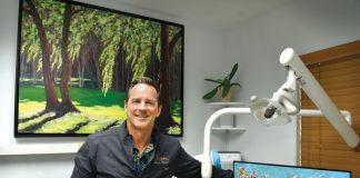 Dr. Hagood displays his art at his dental office, the Vero Beach Art of Dentistry, for his patients to enjoy. This painting of the Vero Beach Country Club golf course was the first piece he ever sold. A recent creative trade brought the painting back to his office. Photo by Kelly Rogers