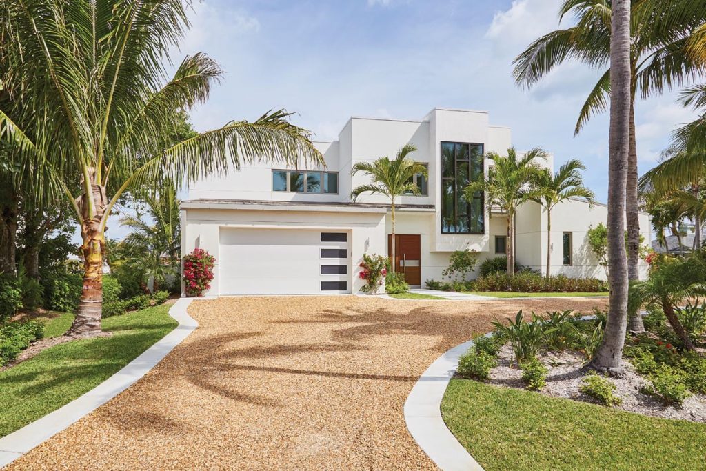 The home is set back on its lot and employs projecting and receding spaces to break down its scale; both elements help it blend in to its location. Photo by Aric Attas