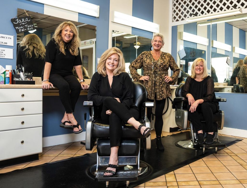 Beach Barber Shop owner Janine Pfarr (seated, front) has a team of all women Guylaine Pelletier, Tara Pribula, and Susan Gallagher.
