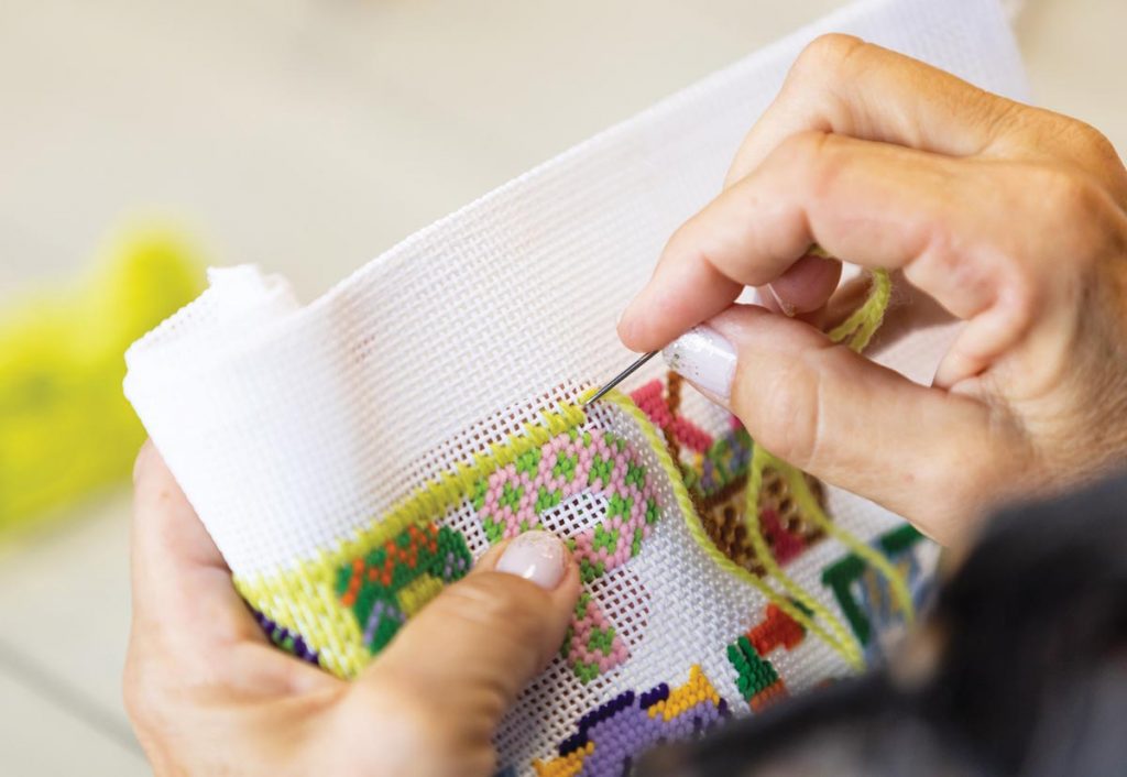 Stitchers believe needlepointing exercises your brain and improves your mood. Photo by Sam Wolfe
