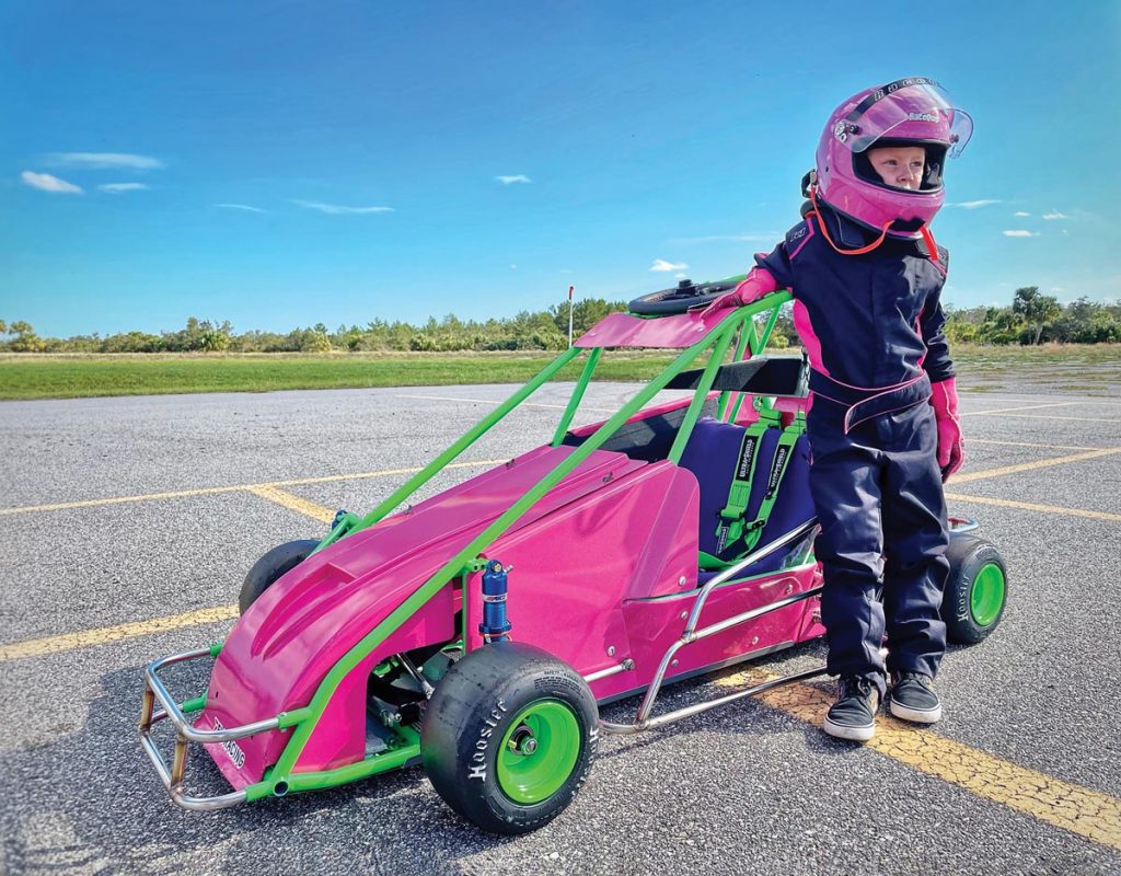Already an experienced quarter midget driver at age 7, Lily Lampp is proud of her new race car, custom painted in her favorite colors. Photography by Bryant Lampp