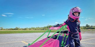 Already an experienced quarter midget driver at age 7, Lily Lampp is proud of her new race car, custom painted in her favorite colors. Photography by Bryant Lampp