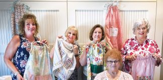 Bridget Lueck, Karen Alexander, Dinah Gabany, Sidney Payne, and Diane Pinelle show some of the pillowcase dresses they have created