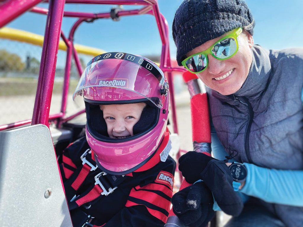 Lily and mom Lauren can be all smiles because quarter midget safety equipment, some of which is visible here, is serious business