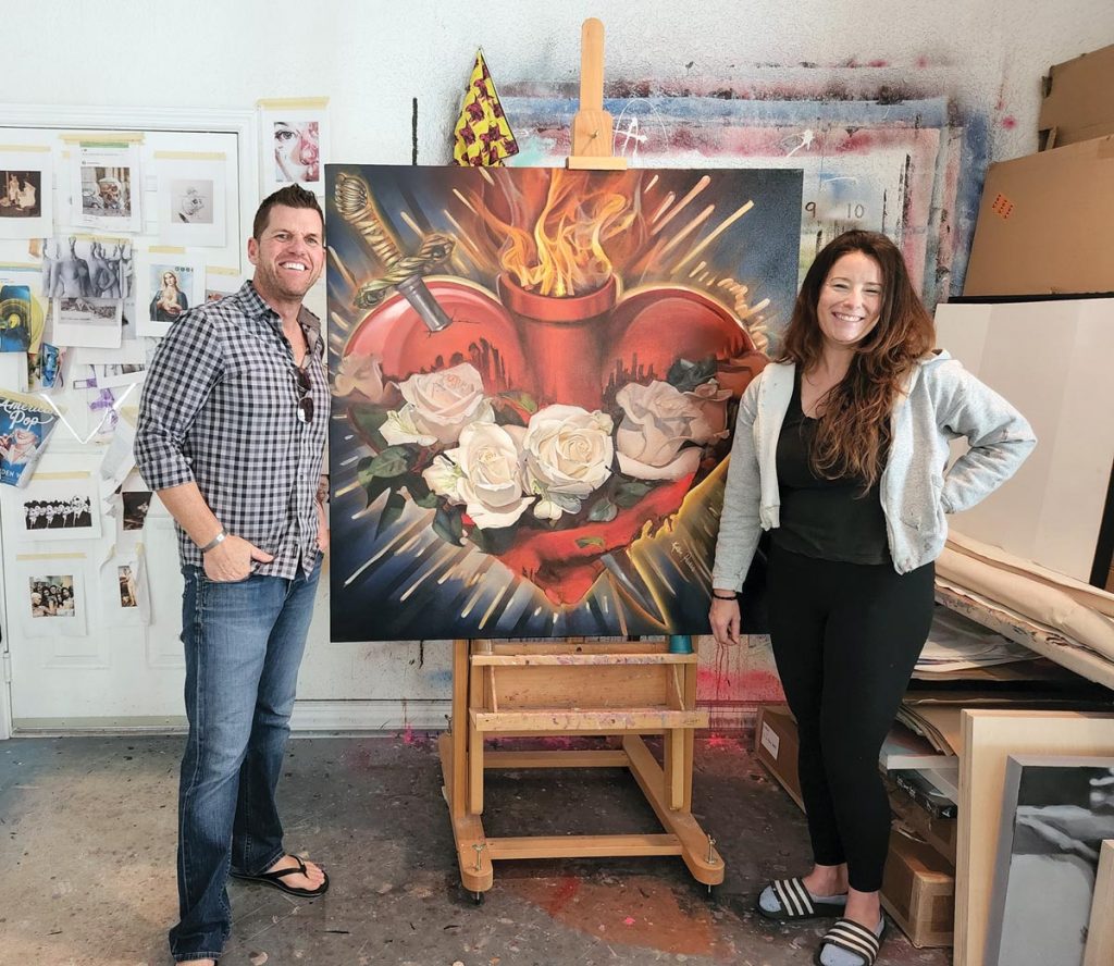 Jeff Palleschi and artist Kristin Pavlick with the Immaculate Heart of Mary painting he commissioned to hang in the distillery in honor of his mother