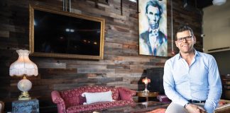Jeff Palleschi sits in the bar area that’s filled with antiques and comfortable seating. Photo by Steven Martine
