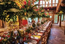The Art of the Festive Holiday Tablescape The decor reflects the enormity of the mahogany table it’s presented on, along with the size of the Hall of Giants at McKee Botanical Garden. Photo by Marion de Vogel