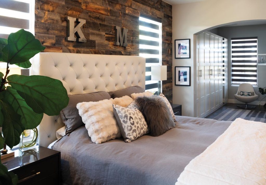 The primary bedroom suite is a soothing and relaxing area with cool tones and soft fabrics. Photo by Jerry Rabinowitz