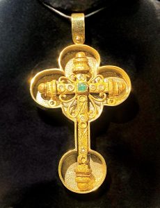 A gold, emerald, and diamond cross was found in pieces in 1996. Photo by Kelly Rogers