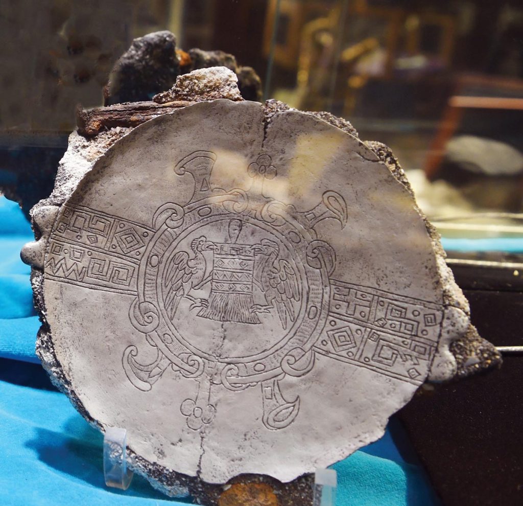 This intricately carved silver plate may be of Inca origin. Photo by Kelly Rogers