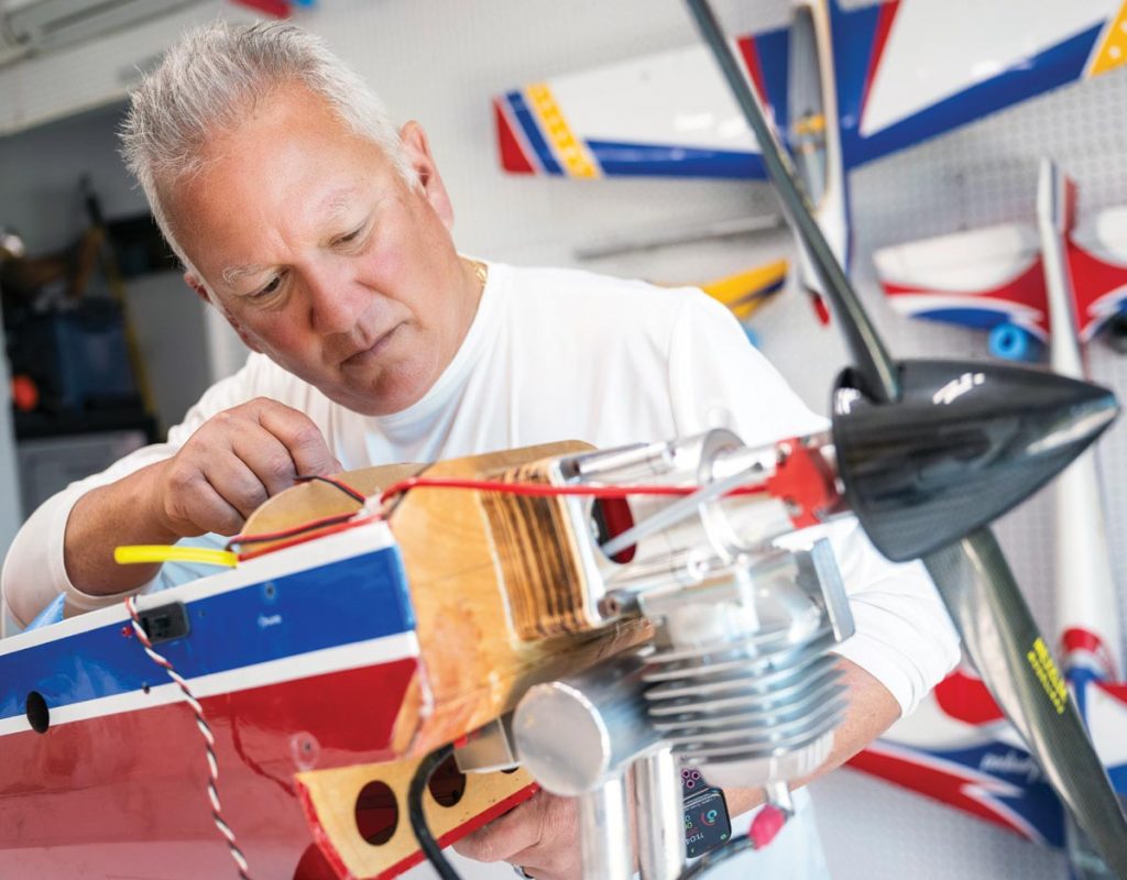Conway Bolt, president of the Airmasters RC club, works on one of his remote-controlled planes. Photo by Steven Martine