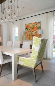 One popular wing chair placement is at the end of the dining table. Photo by Coastal Interiors