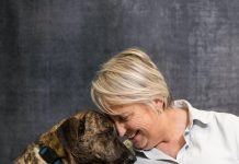 Working Hand in Paw Operations director Nichola Redmond encourages shy shelter dog Vada. Photo by Steven Martine