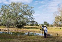 Katherine Larson Paints the Views of Vero Beach Vero Beach artist Katherine Larson brings the newest member of her family, Aria, on a trip out to paint at Hammock Ranch Preserve. Photo by Steven Martine