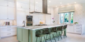 Coastal Interiors uses large-scale slabs of stone in every room of the house, including on the kitchen island and countertops. Photo by Owen McGoldrick