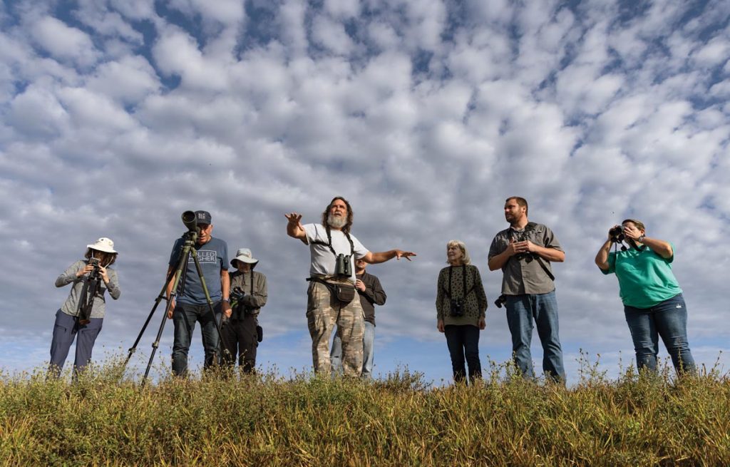 David Simpson leads a group of birdwatchers at the Stick Marsh. Photo by Sam Wolfe
