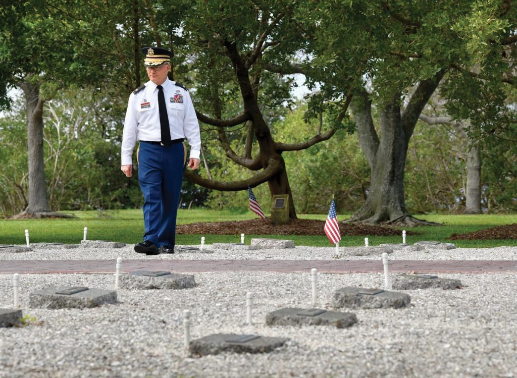 Tony Young strolls among the cenotaphs at Memorial Island, reviewing the names, each of which is familiar to him. Photo by Kelly Rogers