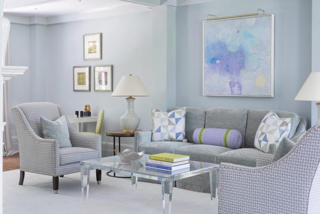 An acrylic coffee table placed by Sandra Morgan in this living area adds sparkle but allows the painting to be the focus in the room