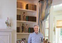 Kim Anderson Creates a Treasure Trove Throughout his home, Kim Anderson, pictured here with Tiger Lilly, his Yorkshire Terrier, displays art he’s collected over the years. Photo by Jerry Rabinowitz