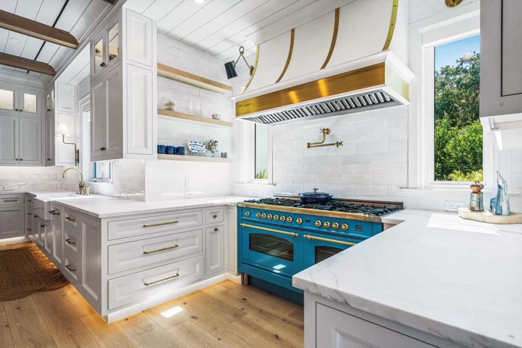 The blue Ilve gas range, top, is the centerpiece of the space, contrasting with the white cabinets and countertops. Photo by M. James Northen