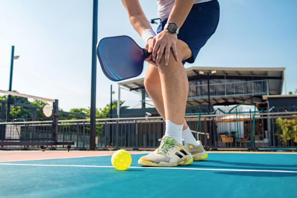 Injuries can be avoided when players stretch and warm up on the court before competing. Photo courtesy of iStock