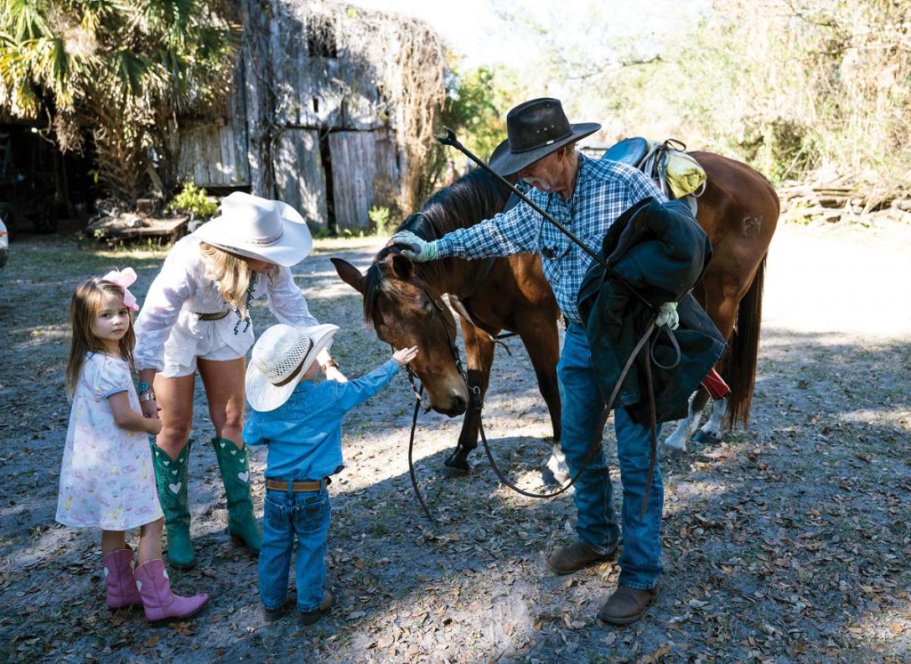 Mac and Emmy Tate, above, make friends with a horse at the farm. Photo by Steven Martine