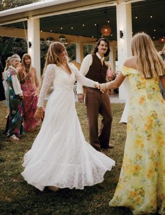 The bride and groom dancing with guests at the reception. Photo by LXS Photos