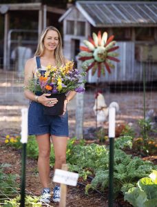 Summer Almand gathers flowers. Photo by Steven Martine