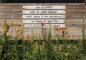 The phrases on this sign describe the students who frequent the farm. Photo by Steven Martine