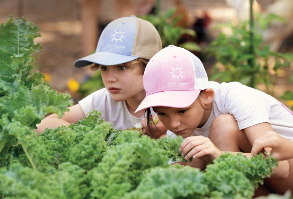 Zander and Evie show that children’s natural curiosity can be harnessed to teach them about nature and food sources. Photo by Steven Martine