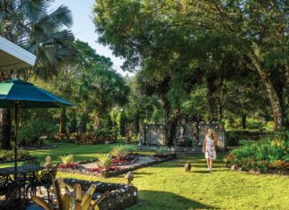 Vero Beach Couple Creates a Grotto Garden in Their Backyard Cathi Bates walks among Il Giardino della Grotta. Photo by Steven Martine
